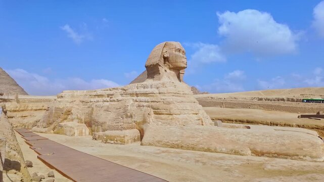 Slow motion panning shot of the famous great sphinx of giza, a limestone statue of a reclining sphinx, a mythical creature in egypt