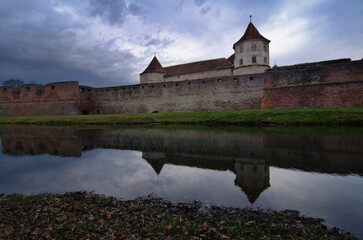 Fototapeta premium Reflection of medieval Fagaras Fortress in water moat