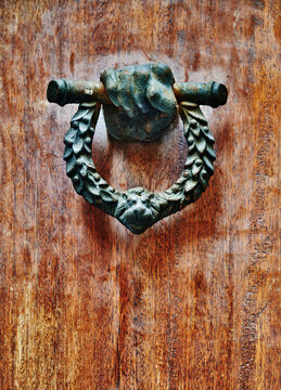 vintage cast iron "Wellington" door knocker featuring a hand gripping a lion-headed laurel wreath, Genoa, Italy, Europe 