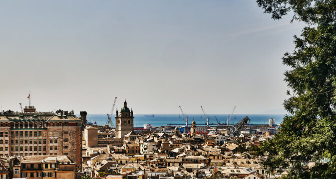 panoramic view of Genoa, Italy, overlooking the dense roofs of the historic center toward the Mediterranean Sea, Europe 
