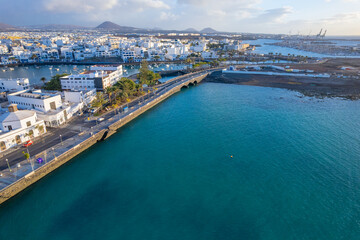 Fototapeta premium Aerial drone view of the beauty of Arrecife town on Lanzarote island through breathtaking aerial views showcasing the coastline, local buildings, and scenic landscape
