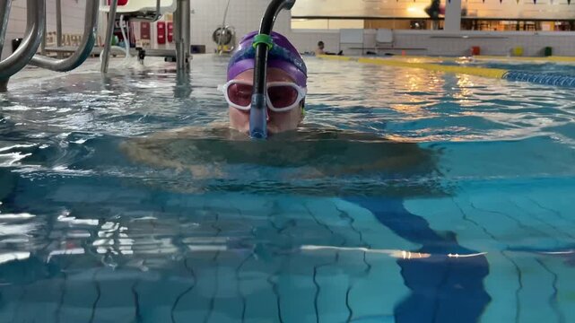 Woman Training in Indoor Swimming Pool