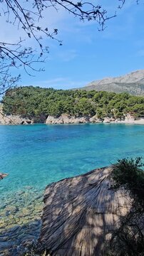 Wooden Beach Cabanas on Blue Sea Coast with Mountain View Montenegro