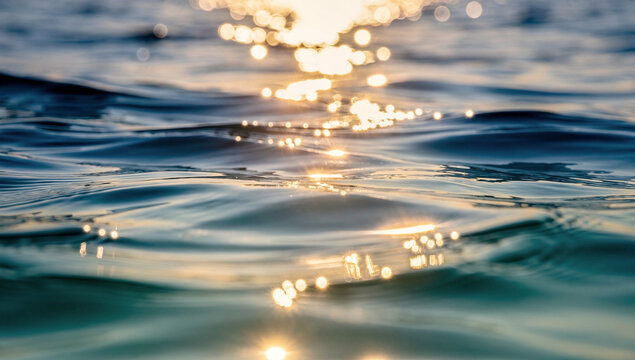 Golden Sunset Reflection on Deep Blue Ocean Waves with Sparkling Bokeh