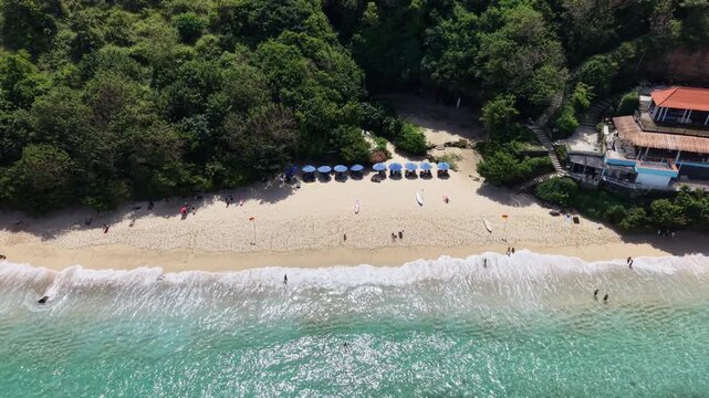 Aerial Drone Shot of Gunung Payung Beach with Turquoise Waves and Limestone Cliffs
