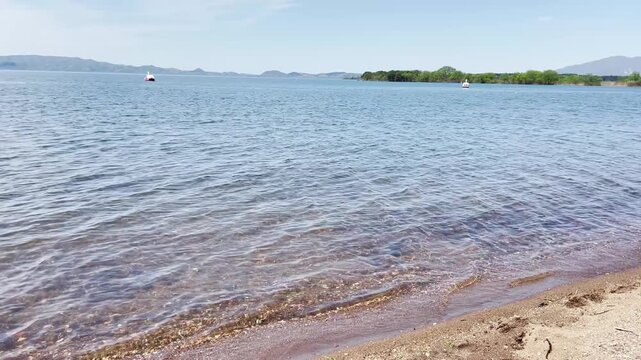 【風景】風に揺れる波とスワンボートのある湖畔の砂浜の風景｜A Lakeside Sandy Beach with Wind-Rippled Waves and Swan Boats