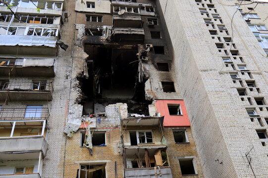 Russian missile strike destroyed house in Dnipro, Ukraine. A large hole in residential building after drone strike and a fire. Russia s war against Ukraine.