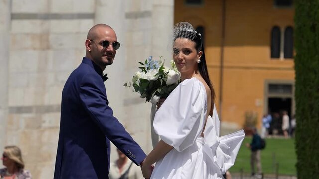 Happy newlyweds enjoying a festive celebration outdoors near famous city monuments and architecture