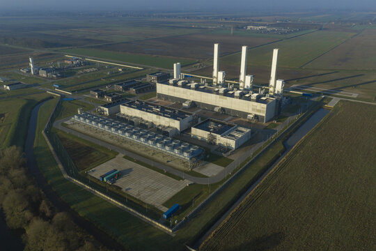 Aerial view of the nitrogen plant facility with tall white chimneys and industrial buildings surrounded by green fields Zuidbroek, Groningen, Netherlands.