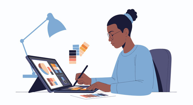 A woman celebrates Juneteenth Day by designing illustrations on her laptop and digital drawing tablet at a desk with a lamp.