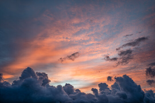 High Humidity Sunrise Above Manoa Hawaii with a Red Sky at Dawn and Building Cumulus  Clouds.