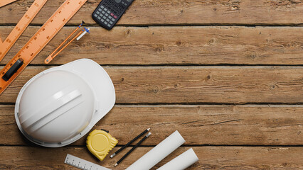 Fototapeta na wymiar Top view of engineering equipment and construction tools arranged on wooden table with copy space