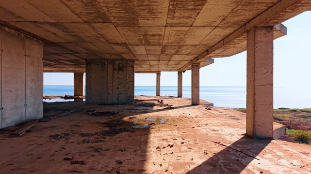 Footage inside the frame of the high-rise structure with some rubbish on the floor. Empty unfinished abandoned construction.