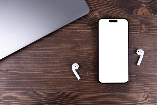 mockup iPhone smartphone with png transparent empty screen blank, template on a wooden table. Batumi, Georgia - March 18, 2026