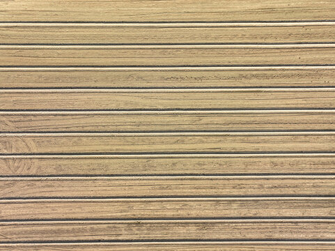 Aerial view of a plowed agricultural field with parallel horizontal furrows and earthy textures in Borgo d'Ale, Piedmont, Italy.