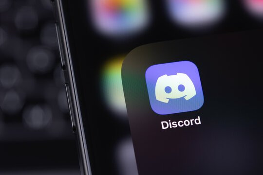 Discord mobile icon app on a screen smartphone iPhone. Discord is a cross-platform proprietary instant messaging system with support for VoIP and video conferencing. Batumi, Georgia - March 25, 2026