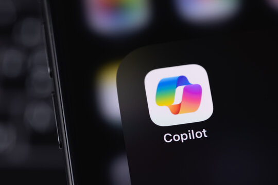Microsoft Copilot logo mobile icon app on a screen smartphone iPhone. Microsoft Copilot is an artificial intelligence assistant for Microsoft 365 apps and services. Batumi, Georgia - March 25, 2026