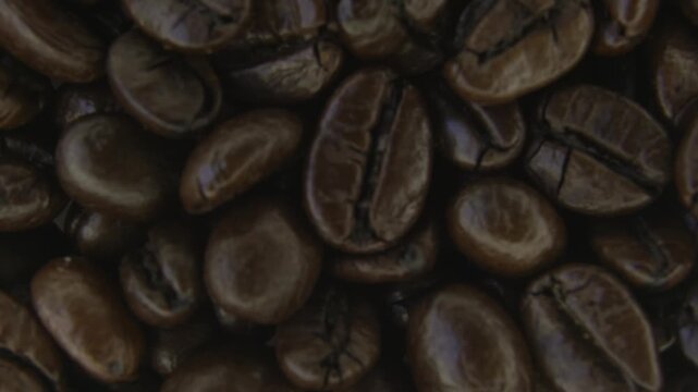 Macro Rotation of Coffee Beans and Soft Smoke.