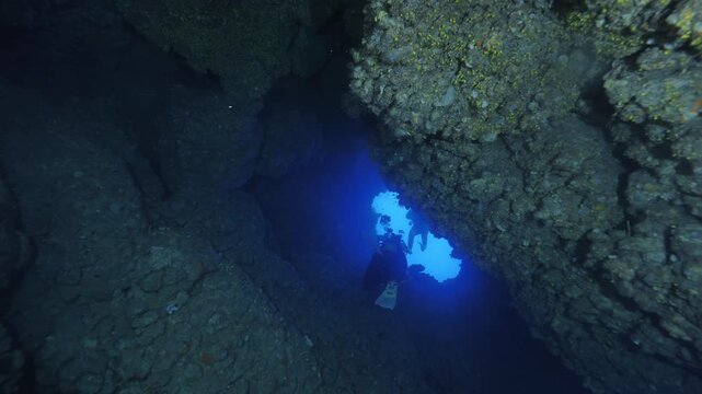 scuba divers exploring caves underwater cave diving