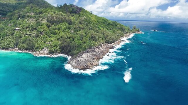 Vacation travel holidays and recreation on beach concept. Tropical beach with sea and palm taken from drone. Praslin island, Seychelles. Slow motion