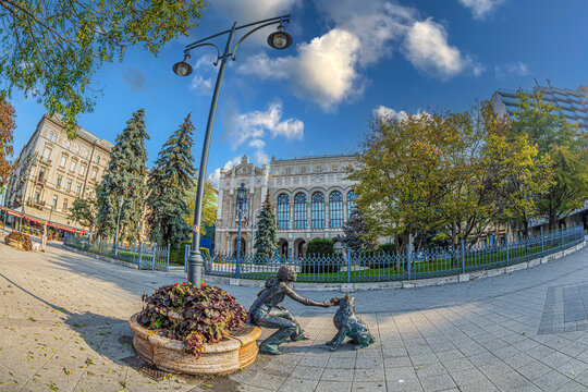 BUDAPEST, HUNGARY - OCTOBER 15, 2022: The statue with Girl With Her Dog (Hungar: Kuty&aacute;s l&aacute;ny-szobor), by sculptor David Raffai, at Vigado Square.