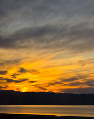 Fototapeta premium Dramatic Golden Sunset Over Water from Interstate 90 Bridge in Washington State