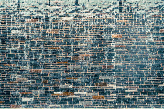 Brick Wall Mosaic Art captured interacting naturally in an outdoor setting, in a clean visual environment, under daylight, with a natural mood, suitable for marketing, editorial.
