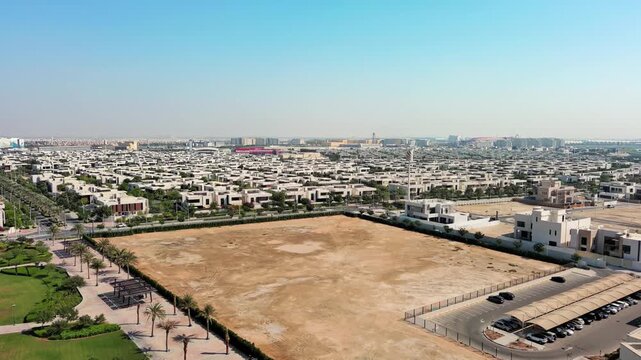 Aerial view of the modern Yas Acres residential community on Yas Island, Abu Dhabi, UAE, featuring luxury villas, contemporary architecture, and lush suburban development near the mangroves.
