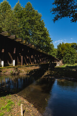 Fototapeta premium landscape with an old steel railway bridge crossing the river