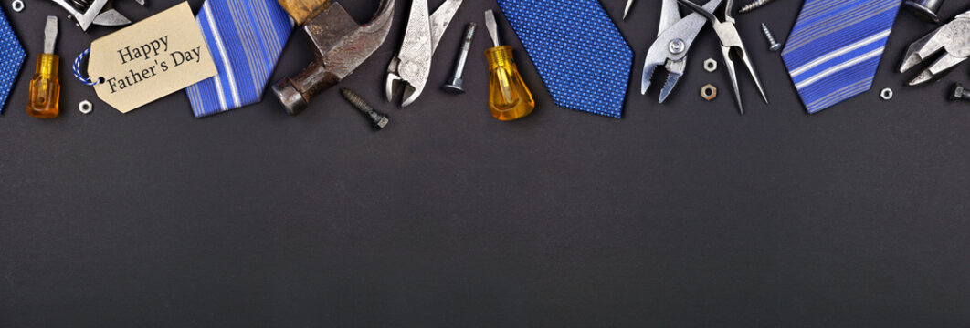 Happy Fathers Day gift tag with top border of ties and tools on a black paper banner background. Overhead view with copy space.
