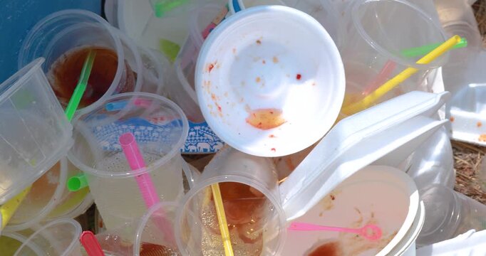 Plastic waste pile including cups and foam containers, Garbage pile, Plastic waste, Pollution, Waste management issues, and environmental impact, close-up