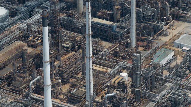 Aerial view of the Eastern Economic Corridor of Innovation EECi with its complex network of industrial pipes, tall chimneys, and steel structures in Tambon Pa Yup Nai, Chang Wat Rayong, Thailand.