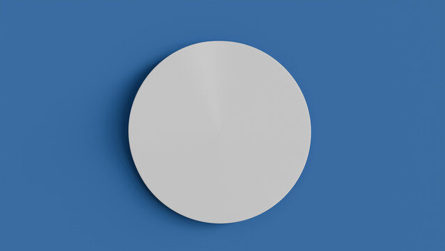 Blank white round sheet of paper on blue background with shadow used as note template, round sticker