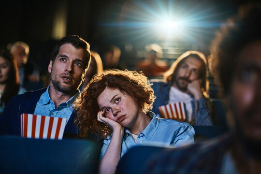 Bored audience watching a movie in a cinema