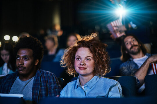 Friends watching a movie in a cinema theater