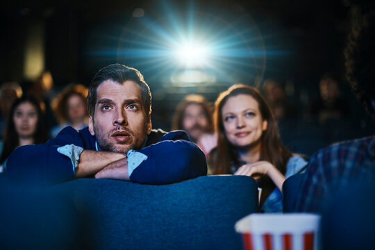 Captivated audience watching movie in cinema theater