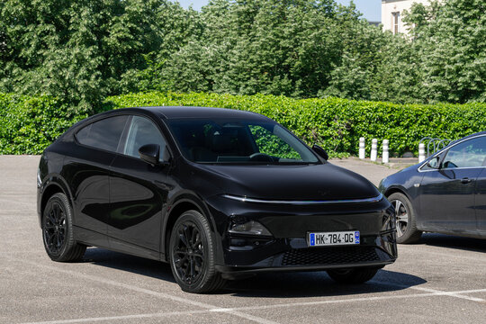Nancy, France - May 9th 2026 : View on a black Xpeng G6 Performance finished in Midnight Black parked on a parking lot with vegetation in the background.