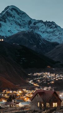 Stepantsminda, Georgia. Evening Bright Starry Sky With Glowing Stars Above Peak Of Mount