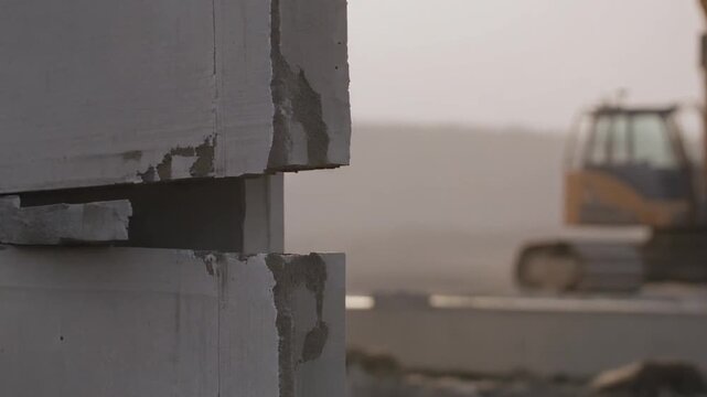 Construction Site with Concrete Blocks and Excavator