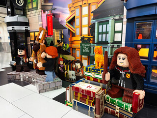 Naklejka premium Lego Harry Potter character display in London UK with Hermione, Hagrid and Ron staged as colorful brick sculptures at a bookstore style wizarding scene