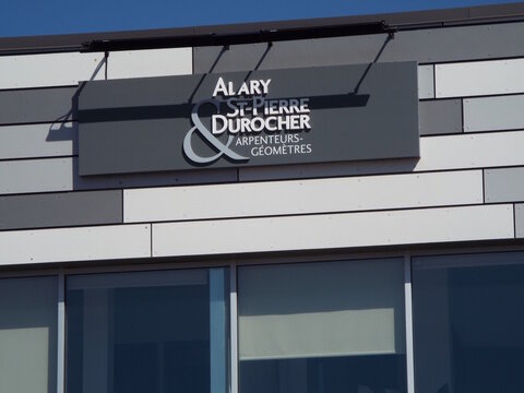 Gatineau, Quebec, Canada &ndash; April 18, 2026: The "Alary St-Pierre & Durocher" storefront features a dark gray sign with white text above modern, neutral-toned wall paneling at  900 Bd de la Carri&egrave;re Uni