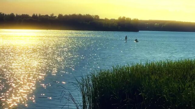 Scenic Golden Hour Paddleboarding on Calm Lake with Sparkling Water