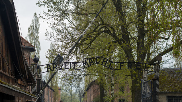 The "Arbeit Macht Frei" gate at Auschwitz I concentration camp in Oswiecim, Poland. Iconic entrance of the Holocaust memorial and museum. Oswiecim, Poland - April 21, 2026.