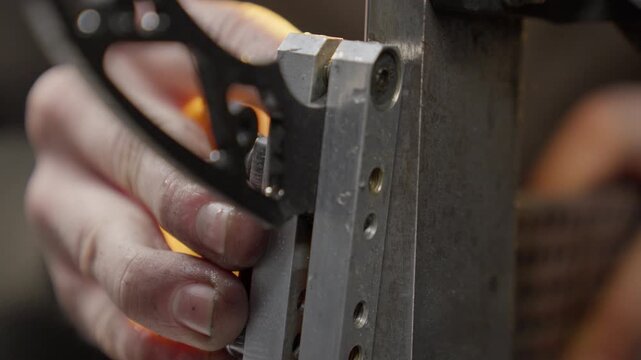 Knife is sharpened by blacksmith in workshop during making