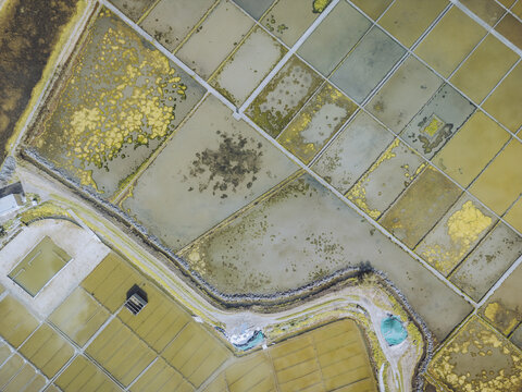 Aerial view of colorful salt evaporation ponds and geometric patterns in Aveiro Salt Marshes, Aveiro Lagoon, Gloria, Aveiro, Portugal.