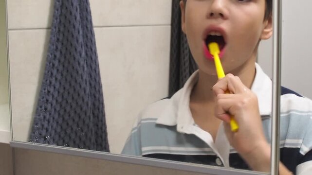 Boy is brushing teeth, close-up