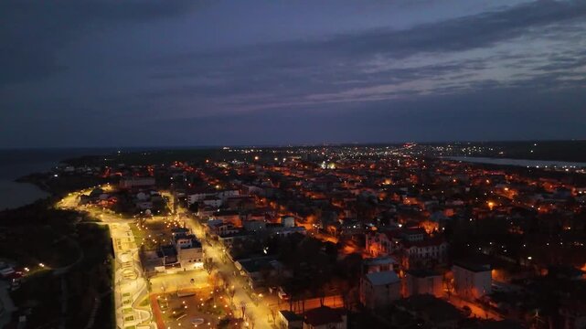 Night Aerial View of Techirghiol Town with City Lights and Sunset Sky Romania