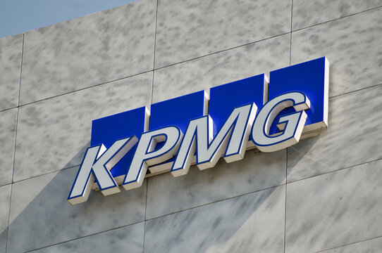 KPMG company sign hanging on a building in Lugano, Switzerland