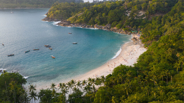 Aerial view of Freedom Beach featuring white sand, turquoise water, longtail boats, and lush green jungle in Tambon Patong, Chang Wat Phuket, Thailand.