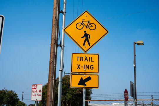 Yellow diamond sign warns of trail crossing for pedestrians and cyclists